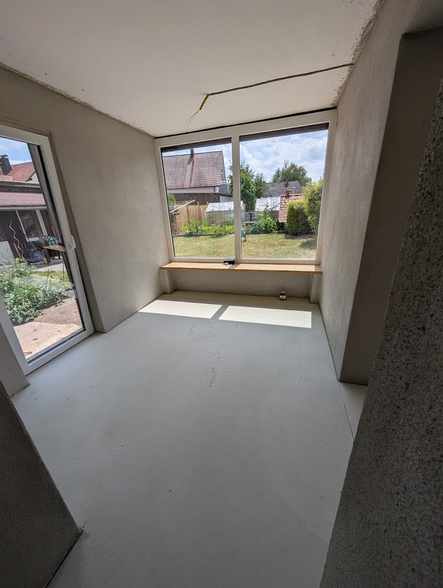 Neuer Estrich in einem Wohnraum mit bodentiefen Fenstern